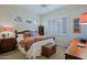 Cozy bedroom features a ceiling fan, stylish furnishings, and shuttered windows providing natural light and privacy at 33242 N 68Th Pl, Scottsdale, AZ 85266