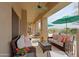 Inviting covered patio features comfortable seating, perfect for relaxing and enjoying the outdoor views at 33242 N 68Th Pl, Scottsdale, AZ 85266