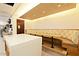 Modern dining area with long booth seating, sleek island, and ample countertop space at 33242 N 68Th Pl, Scottsdale, AZ 85266