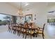 Formal dining room with a large window, chandelier, and seating for 12 at 33242 N 68Th Pl, Scottsdale, AZ 85266