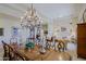 Dining room with a large table, chandelier, and views of the living room at 33242 N 68Th Pl, Scottsdale, AZ 85266
