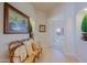 Inviting hallway with decorative bench and artwork leading to bedroom at 33242 N 68Th Pl, Scottsdale, AZ 85266