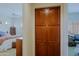 Hallway closet with paneled wood doors that provides organized storage space between two bedrooms at 33242 N 68Th Pl, Scottsdale, AZ 85266