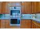 A close up view of the oven, cabinets, and countertops at 33242 N 68Th Pl, Scottsdale, AZ 85266