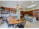 Well-lit kitchen with a dining nook and extensive cherry wood cabinets with granite countertops at 33242 N 68Th Pl, Scottsdale, AZ 85266