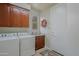 Functional laundry room featuring modern appliances, ample cabinet space, and a utility sink at 33242 N 68Th Pl, Scottsdale, AZ 85266