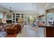 Spacious living room with fireplace, open to dining area and kitchen, with natural light at 33242 N 68Th Pl, Scottsdale, AZ 85266