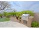 Outdoor kitchen area boasts a stainless steel grill and cooking space, perfect for outdoor dining and entertaining at 33242 N 68Th Pl, Scottsdale, AZ 85266