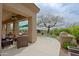 Covered patio with comfortable seating, an outdoor kitchen, and a putting green, perfect for enjoying the outdoors at 33242 N 68Th Pl, Scottsdale, AZ 85266