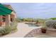Gorgeous pool area with a rock-accented spa, surrounded by colorful desert plants, creating a serene backyard retreat at 33242 N 68Th Pl, Scottsdale, AZ 85266