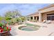 Serene pool and spa area with rock accents, surrounded by beautiful desert landscaping, creating a peaceful retreat at 33242 N 68Th Pl, Scottsdale, AZ 85266