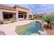 Sparkling swimming pool and patio area, surrounded by desert landscaping and mature trees, creating a private oasis at 33242 N 68Th Pl, Scottsdale, AZ 85266