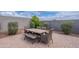 Outdoor patio with dining table and seating, surrounded by lush greenery at 37185 N Falabella Dr, San Tan Valley, AZ 85140