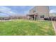 Well-manicured backyard with a covered patio, mature landscaping, and ample green space at 37185 N Falabella Dr, San Tan Valley, AZ 85140