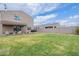 Expansive backyard with covered patio, lush lawn, and space for outdoor activities at 37185 N Falabella Dr, San Tan Valley, AZ 85140