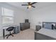 A cozy bedroom is enhanced by a ceiling fan, large dresser, and a functional desk at 37185 N Falabella Dr, San Tan Valley, AZ 85140