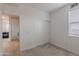 Bright bedroom featuring a closet with sliding doors, a window, and doorway, offering a serene retreat at 37185 N Falabella Dr, San Tan Valley, AZ 85140