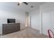 A bright bedroom features neutral walls, light carpeting, and a gray dresser, offering a calm and inviting space at 37185 N Falabella Dr, San Tan Valley, AZ 85140