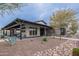 Beautifully landscaped clubhouse exterior with stone detailing and inviting architecture, creating a welcoming community space at 37185 N Falabella Dr, San Tan Valley, AZ 85140