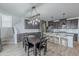 Open dining area adjacent to the kitchen with stylish lighting and wood-look flooring at 37185 N Falabella Dr, San Tan Valley, AZ 85140