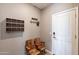 Entryway featuring rustic seating, a coat rack, and a door at 37185 N Falabella Dr, San Tan Valley, AZ 85140