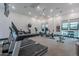 Well-equipped gym with treadmills, weights, and ceiling fan providing a complete workout experience at 37185 N Falabella Dr, San Tan Valley, AZ 85140