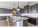 Modern kitchen with stainless steel appliances, granite countertops, an island, and ample cabinet space at 37185 N Falabella Dr, San Tan Valley, AZ 85140