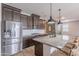 Contemporary kitchen featuring stainless steel appliances, granite counters, and an island with seating at 37185 N Falabella Dr, San Tan Valley, AZ 85140