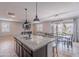 Open concept kitchen showcasing an island with seating, connecting to the dining and living areas at 37185 N Falabella Dr, San Tan Valley, AZ 85140