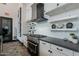 Well-equipped kitchen with stainless steel gas range, modern cabinetry, and subway tile backsplash at 37185 N Falabella Dr, San Tan Valley, AZ 85140