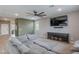 View of living room showcasing a large sectional sofa and mounted TV with console at 37185 N Falabella Dr, San Tan Valley, AZ 85140