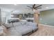 Open-concept living space showing kitchen, dining area, stairs and comfortable sectional sofa at 37185 N Falabella Dr, San Tan Valley, AZ 85140