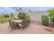 Inviting outdoor dining area with a modern table and comfortable seating, set against a beautifully landscaped backdrop at 37185 N Falabella Dr, San Tan Valley, AZ 85140