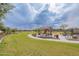 Community playground with picnic tables, climbing structure, and open green space at 37185 N Falabella Dr, San Tan Valley, AZ 85140