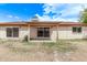 The backyard offers privacy with a covered patio, desert landscaping and block fence at 3941 W Desert Hills Dr, Phoenix, AZ 85029