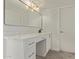 Modern bathroom with white cabinets, countertop, and large mirror at 3941 W Desert Hills Dr, Phoenix, AZ 85029