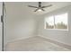 Bright bedroom with laminate flooring, a ceiling fan, and a large window at 3941 W Desert Hills Dr, Phoenix, AZ 85029