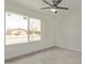 Bedroom featuring wood-look flooring, ceiling fan and a window with neighborhood views at 3941 W Desert Hills Dr, Phoenix, AZ 85029