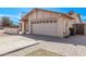 Exterior of home with a two-car garage, stone brick driveway, and blue sky at 3941 W Desert Hills Dr, Phoenix, AZ 85029