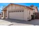 Exterior of home with a two-car garage and stone brick driveway at 3941 W Desert Hills Dr, Phoenix, AZ 85029