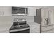 Modern kitchen features stainless steel appliances and beautiful quartz countertops at 3941 W Desert Hills Dr, Phoenix, AZ 85029