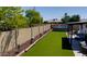 Large backyard includes artificial turf, a pool, and a covered patio for outdoor living at 4038 W Windrose Dr, Phoenix, AZ 85029