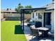 Beautiful backyard with artificial grass, above ground pool, covered patio, and seating at 4038 W Windrose Dr, Phoenix, AZ 85029