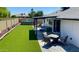 Spacious backyard featuring artificial grass, above ground pool, and covered outdoor entertaining area at 4038 W Windrose Dr, Phoenix, AZ 85029