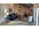 Living room features vaulted ceilings, rustic brick fireplace and access to the backyard through french doors at 4038 W Windrose Dr, Phoenix, AZ 85029