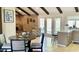 Open living room with brick fireplace, French doors, and modern kitchen with island at 4038 W Windrose Dr, Phoenix, AZ 85029