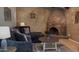 Comfortable living room includes a corner brick fireplace, cozy seating, and rustic decor at 4038 W Windrose Dr, Phoenix, AZ 85029