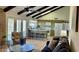 Cozy living room with beamed ceilings, French doors, and an open kitchen at 4038 W Windrose Dr, Phoenix, AZ 85029