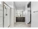 Bright bathroom featuring a dual vanity, framed mirror, walk-in shower, and neutral-toned walls at 4087 W Coneflower Ln, San Tan Valley, AZ 85144