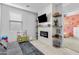 Bonus room with fireplace, TV, kitchen set and doorway to pink bedroom at 4087 W Coneflower Ln, San Tan Valley, AZ 85144